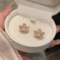 Detailed close-up of French vintage pearl flower zircon stud earrings in a white box - Water Drop Rhinestone Flower Style