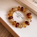 Detail shot of vintage acrylic marbled round bead bracelet with gold spacers in box. - Bracelet / Brown