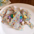Macro view of shell and conch tassel earrings with light blue polka dot ribbon bows - Conch Style / Colorful