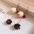 Detailed macro view of vintage handmade pinecone and wooden petal drop earrings on a display tray - Retro Pine Cone Petal Earrings / Ear Hook - Gold