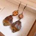 Detailed close-up of vintage handmade wooden drop earrings with natural seed pendants - Geometric Wood Mushroom Earrings / Ear Hook - Gold