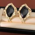 Detailed macro shot of vintage gold-tone irregular geometric earrings with black enamel - Irregular Geometric (Silver Earring Post) / Gold-Black