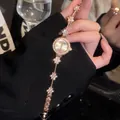 Elegant vintage gold flower bracelet watch with sparkling rhinestones for stylish women - Flower Link Bracelet Watch / Gold