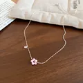 Close-up of a silver necklace with a pink flower pendant and clear zircon detail - Silver-Pink