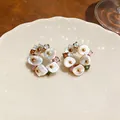 Macro view of French retro flower earrings with pearls and colored stones - Light Coffee Gold With Silver Pin