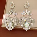 Close-up of vintage heart earrings with sparkling rhinestones and iridescent crystals. - Silver Post AB Color / Silver