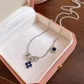 Detail showing blue flower pendant and zircon charms on a silver necklace in a gift box. - Round Flower Style (HN12265) / Silver-Blue