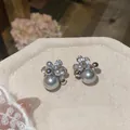 Close-up macro view of elegant gray pearl and cubic zirconia cluster floral stud earrings. - Cluster Stud Earrings (HE32966) / Silver Gray