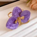 Primo piano dettagliato dell'orecchino a fiore in smalto viola con eleganti accenti dorati - Bangle / Oro Ecologico / Viola