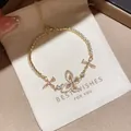 Detailed macro view of a sparkling zircon butterfly and flower bracelet on a gift pouch - 21# Bracelet
