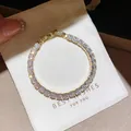 Close-up detail of a sparkling gold-plated tennis bracelet with white cubic zirconia stones - 26# Bracelet