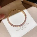Close-up of elegant gold tennis bracelet featuring sparkling pink zircon gemstones. - 27# Bracelet