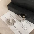 Detailed view of the intricate double-layer cross design on these silver hoop earrings - Hoop Earrings-Silver