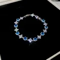 Detailed shot of sparkling blue and white flower zircon bracelet on black velvet. - Style 6 Bracelet