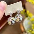 Close-up of sweet enamel flower earrings in transparent spheres with crystal studs. - Oil Drip Flower Icy Style (HE34142) / Rainbow