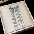Detailed view of silver star tassel ear clips with purple zircon and sparkling stones - Star Tassel Ear Bone Clip / One Pair / Silver with Purple