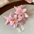 Detailed macro view of pink starfish and satin flower hair clips with sparkling rhinestones - Duckbill Hair Clips / Pink