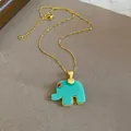 Close-up of a mint green resin elephant pendant necklace with a gold-colored chain. - Elephant Pendant / Green