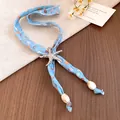 Macro view of ocean-themed scarf necklace with silver starfish charm and shell bead accents - Frosted Silver Starfish Pendant