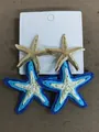 Seaside style blue and white woven raffia starfish pendant earrings with golden metal studs - Silver Earring Post Style / White/Blue