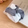 Close-up detail of a double-layered striped fabric and white organza hair scrunchie - Striped / White