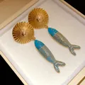 Detail of luxury vintage gold plated fish drop earrings with blue enamel in gift box - Gold & Blue
