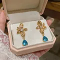 Elegant 18k gold plated flower earrings with blue teardrop zircon crystal - Flower Shape / Gold Blue