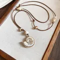 Elegant nautilus shell pendant necklace with brown cord for beach vacation style - Brown-Shell