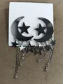 Stylish black moon and star earrings with long silver tassels for a cool vibe. - Silver