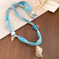 Light blue seaside vacation style fabric necklace with seashell and starfish charms - Blue-Horn Shell