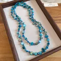 Double-layered blue shell and crystal bead necklace for a seaside vacation style. - Blue