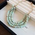 Triple-layered beach style necklace with light blue flat beads and gold chain - Gold-Blue