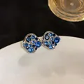 Close-up of elegant hollow square stud earrings with sparkling blue rhinestones - Hollow Square Studs (HE33390) / Silver Base - Blue Rhinestone