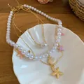 Double-layered beach style necklace featuring faux pearls and elegant starfish charms - Gold & White & Multicolor