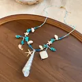 Bohemian beach vacation style necklace with white shells and blue turquoise beads - Gold-Blue