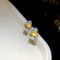 Macro view of exquisite square yellow zircon stud earrings with sparkling halo detail - Earrings / Silver-Yellow