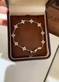 Primo piano dei delicati motivi floreali in zircone e delle pietre turchesi del bracciale. - Bracciale-Argento-Blu