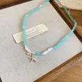 Handmade beach style teal beaded necklace with silver starfish and shell charms. - Silver-Blue