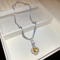 Close-up detail of a sparkling square yellow zircon pendant on a luxury tennis necklace - Necklace / Silver-Yellow