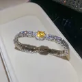 Close-up of a luxury square yellow zircon bracelet with shimmering diamond accents. - Bracelet / Silver-Yellow