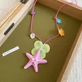 Handmade beach style pink cord necklace featuring resin starfish and flower pendants - Pink-Green
