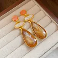Close-up of vintage resin water drop earrings with golden finish and marble texture - Water Drop Style (HE32043) / Brown