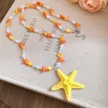 Beach style double layer faux pearl necklace with orange and yellow starfish charms - Yellow