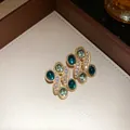 Macro close-up detail of vintage style earrings with green resin gems and crystal inlay - Earrings Only (Without Necklace) / Green