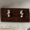 Elegant gold-plated stud earrings featuring oval white pearls and shimmering zircons - Gold-Beige