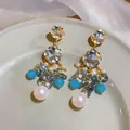 Elegant long blue beaded earrings with clear crystals and iridescent pearls. - Gold-Blue