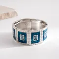 Detailed view of retro silver-tone elastic bracelet with blue enamel spiral panels - Silver-Blue