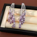 Detailed close-up of 18k gold plated earrings featuring purple teardrop zircon tassels - 18K Gold Plated (HE34037) / Silver-Purple
