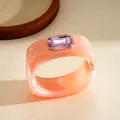 Dettaglio ravvicinato del bracciale geometrico quadrato in resina rosa con gemma viola - Rosa
