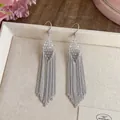 Elegant silver-tone chain tassel earrings with faceted clear rhombus bead accents - White